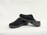 Black slip-on shoes with white soles