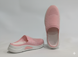 Pair of pink slip-on shoes with white soles