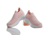 Pair of pink slip-on shoes with white soles