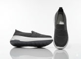 Pair of black slip-on shoes with white soles