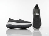 Pair of black slip-on shoes with white soles