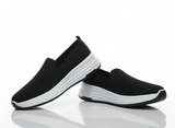 Black slip-on shoes with white soles