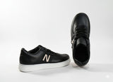Black sneakers with a text "N"