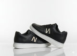 Black sneakers with a text "N"