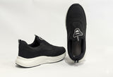 Black slip-on shoes with white soles
