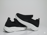 Black slip-on shoes with white soles
