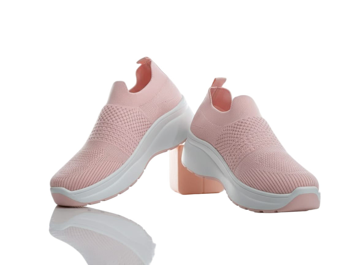 Pair of pink slip-on shoes with white soles