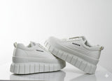 White sneakers with 'FASHION' text 