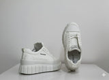 White sneakers with 'FASHION'
